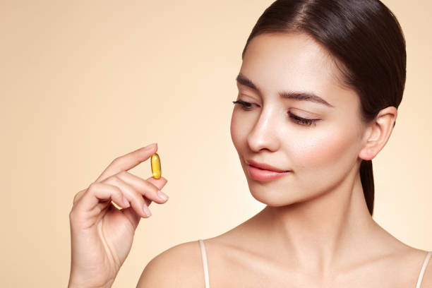 istock Beautiful Girl With Pill With Cod Liver Oil Omega-3 1761160063