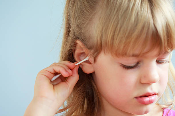istock Girl cleaning ear with Q-tip 176116233