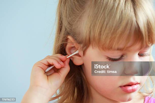 Girl Cleaning Ear With Qtip Stock Photo - Download Image Now - Cotton Swab, Child, 6-7 Years