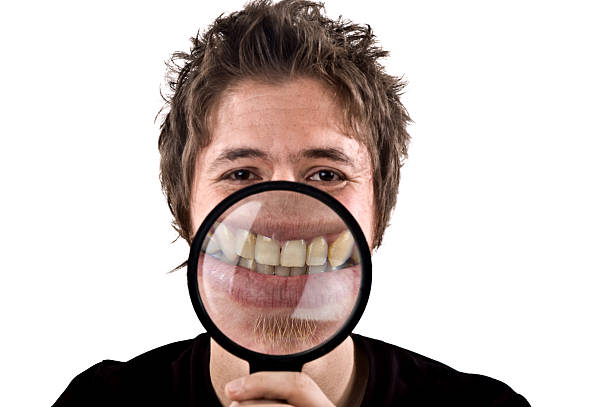 istock toothy smile with magnifying glass 176116647