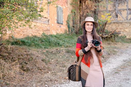 Female artist photographer enjoying autumn in the countryside