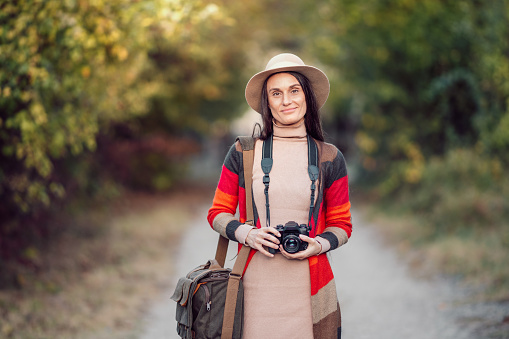 Female photographer enjoys autumn weather