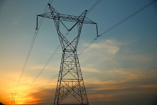 Electric power transmission lines over sunrise