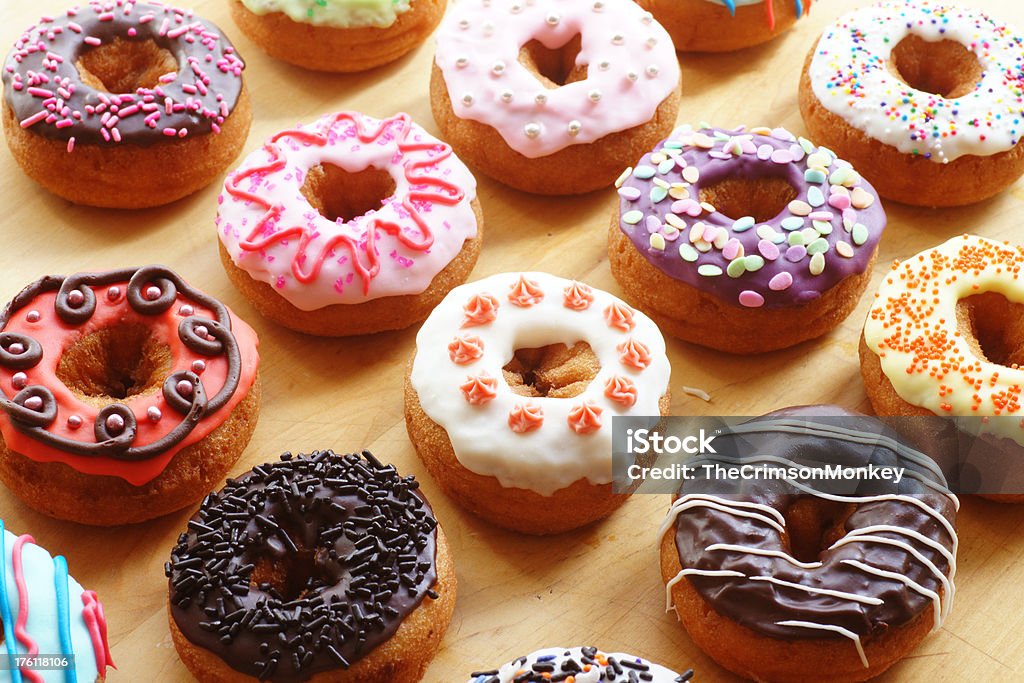 Doughnuts A large group of freshly baked and hand-decorated doughnuts.These doughnuts shot vertically and isolated: Decorating Stock Photo