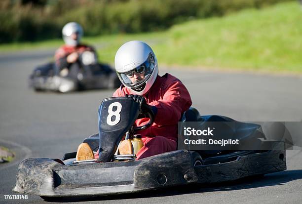 Go Cart Racing On Track Stock Photo - Download Image Now - Adults Only, Competition, Crash Helmet