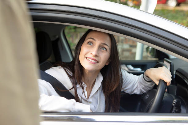 istock Cheerful female car driver looking at her friend 1761186343