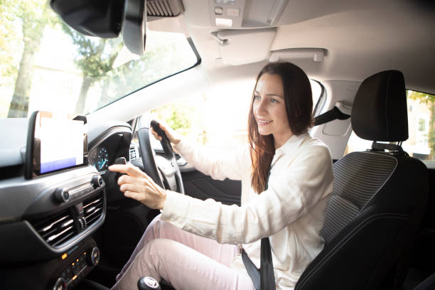 istock Female driver inside a car setting the digital display before starting a journey 1761186873