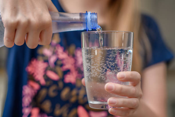 istock Cold water in a plastic bottle poured into a glass 1761190160