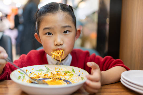 istock Little girl eating spaghetti 1761191264