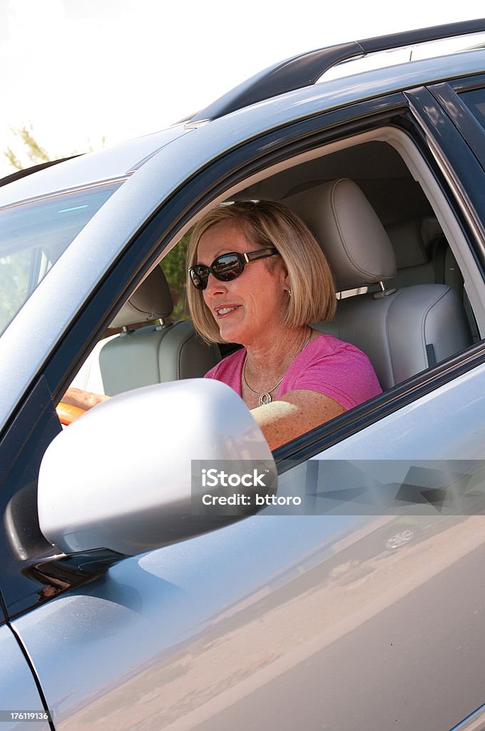 Women Driving Car Smiling, Vertical Digital capture of portrait senior citizen women driving. Driver's Seat Stock Photo