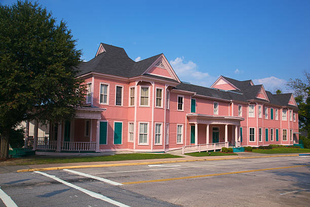 Pink Historic Office Building that Looks Like Apartments XXXL Pink building looks like senior assisted living apartments in Macon's restored downtown district in good conidition and wheelchair access to living quarters but is actually a historic office building with rental facilities for meetings, banquets, wedding receptions, etc (5dmk2) freshly painted road markings stock pictures, royalty-free photos & images