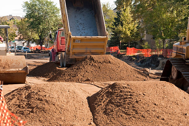 istock mounds of dirt and dump trucks 176119657