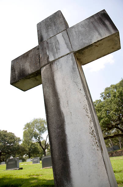 istock Low Angle View of Rustic Cross at a Cemetery 176119939