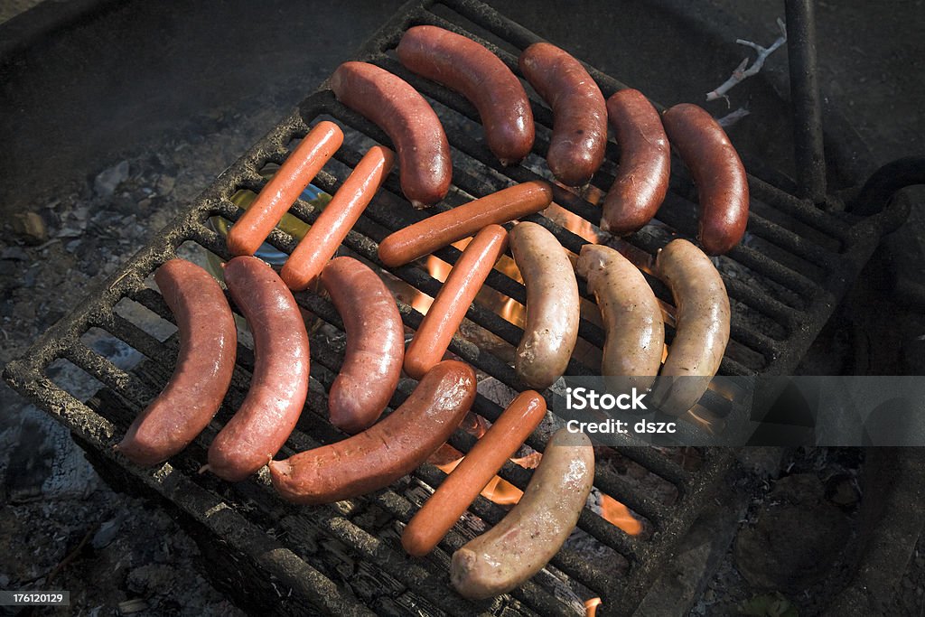 hot dogs roasting on a campfire grill hot dogs roasting on a campfire grill.Check out our other food shots Barbecue - Meal Stock Photo