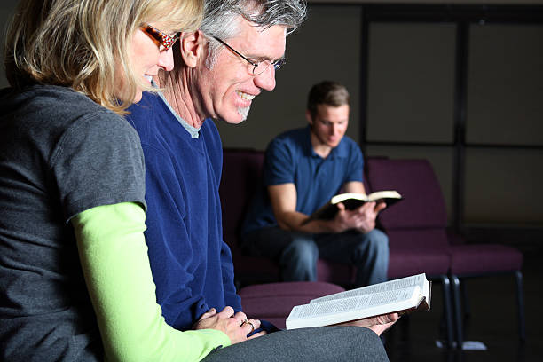 istock Adults and teenager reading Bible. 176120556