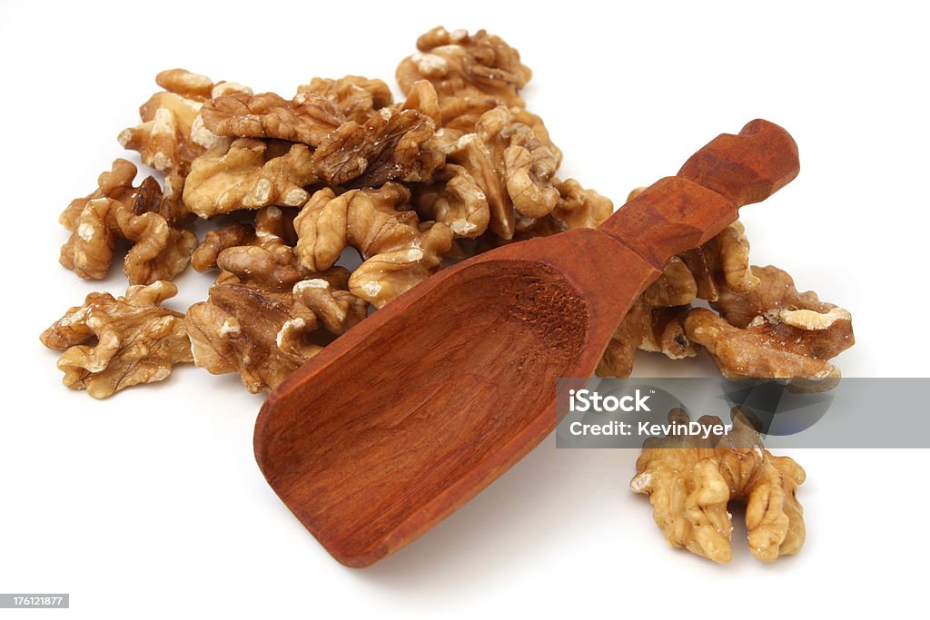 Walnuts Isolated on White Walnuts with wooden scoop isolated on whitePlease see some similar images from my portfolio : Close-up Stock Photo