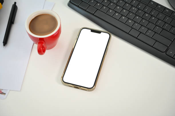 istock Modern workplace with smartphone, cup of coffee and document on white office desk 1761220182