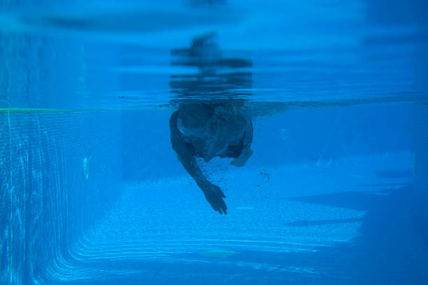 istock Young woman swimming in pool 176122174