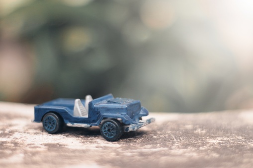 photo of a blue toy car with a blurred background