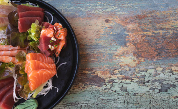 istock Sashimi sushi mounted on lettuce leaves on a worn background with space for text 1761230960