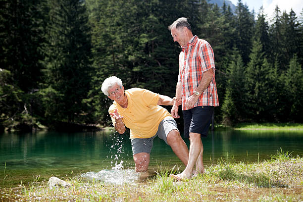 istock elderly couple refreshing in cold mountain lake 176123208