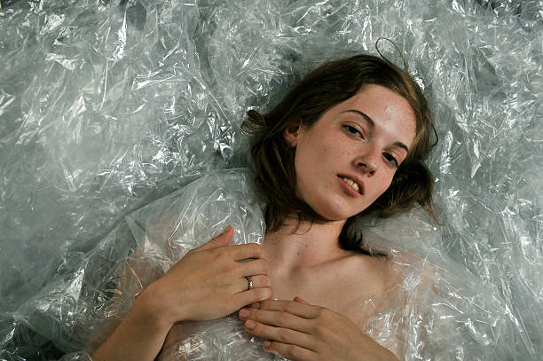 istock Naked girl wrapped in plastic 176123574