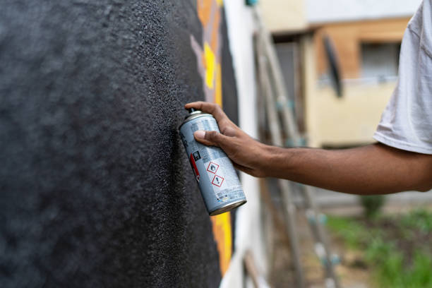 istock Hand of graffiti artist spraying a wall 1761235758