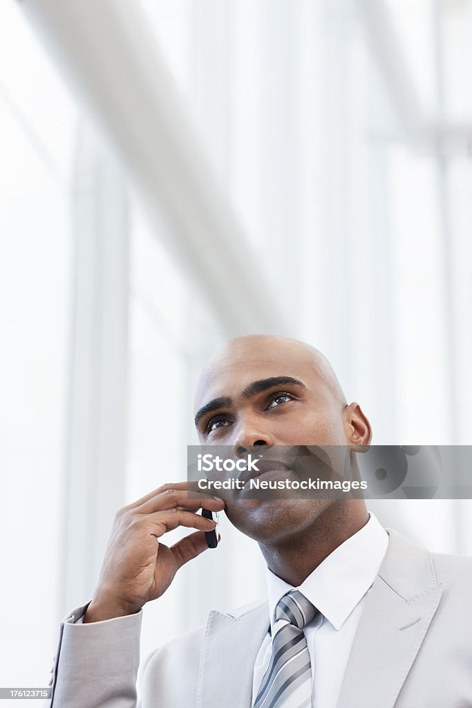 Young businessman talking on a cellphone Young African businessman talking on a cellphone 20-24 Years Stock Photo