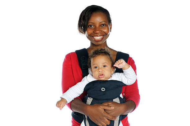 A mother carrying her baby in a sling
