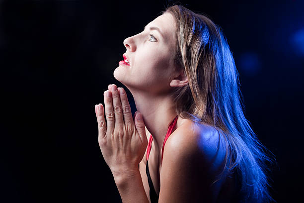 istock Woman Praying In The Dark 176124396
