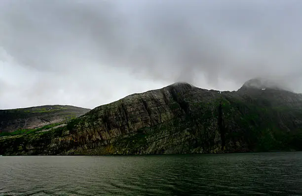 A typical landscape captured by one of the many fjords in northern Norway. Shot in stormy weather.