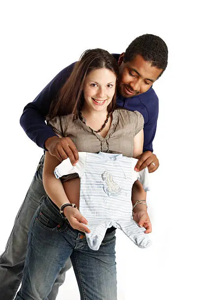 A mixed race couple expecting their first baby. In pleasant anticipation...