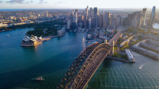 Aerial drone view of Sydney City and Sydney Harbour showing Sydney Harbour Bridge, NSW in the late afternoon