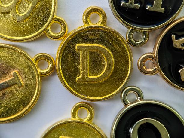 istock gold initial 'D' pendant in the middle of several letters 1761275684