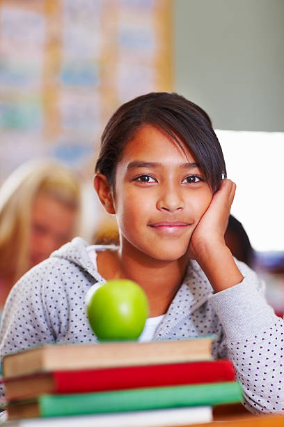 istock Girl with green apple kept on her books 176127981