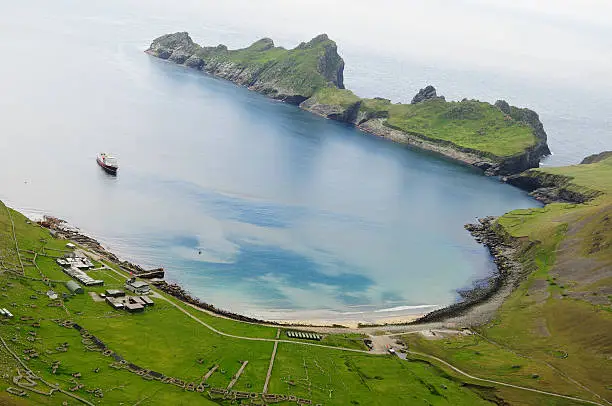 "The St Kilda island of Hirta from the sky. The view is of Village Bay and the abandoned village  there. A small cruise ship sits at anchor in the bay,"