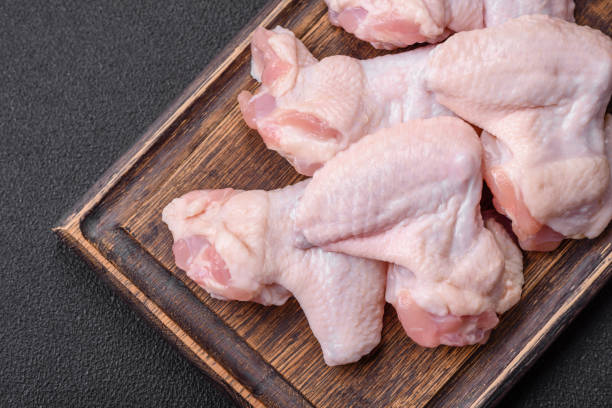 istock Fresh raw chicken wings with salt and spices prepared for baking 1761296243
