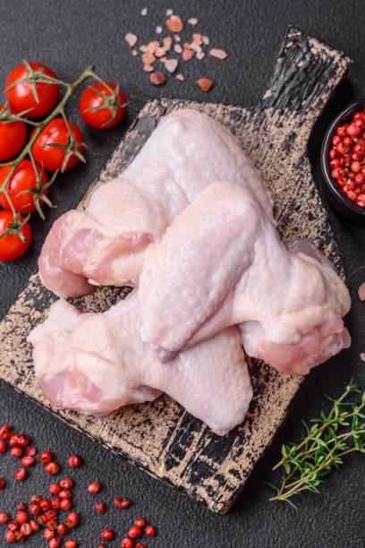 istock Fresh raw chicken wings with salt and spices prepared for baking 1761296760