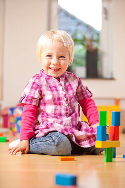istock happy girl is playing with blocks 176130367