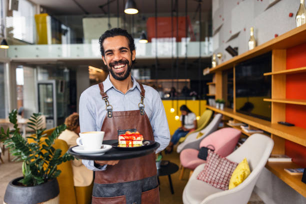 istock Happy Male Middle Eastern Bartender Laughing While Carrying A Tray With Drinks At A Bar 1761309915