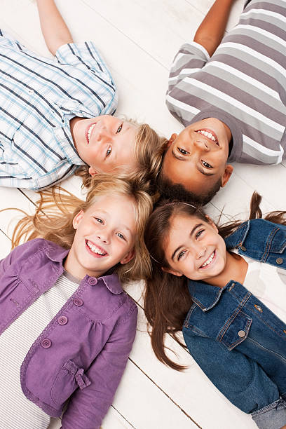 istock Young children lying on floor and laughing 176131007