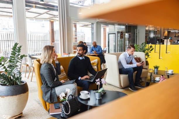 istock Two Diverse Corporate Co-Workers Sitting In A Cosy Cafe And Having A Conversation 1761310488