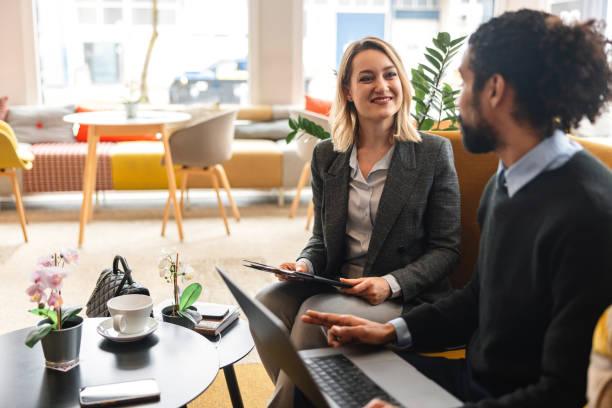 istock Two Happy Diverse Colleagues Having A Conversation At Catching Up In An Office Cafeteria While Working 1761310497