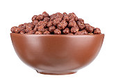 Bowl with chocolate corn balls isolated on white background. File contains clipping path.