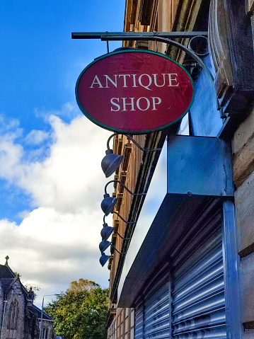 antique shop sign at glasgow scotland england UK