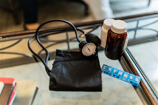 Close-up of a medicine and blood pressure device on table at home