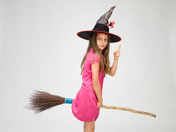 istock Little girl with witch's hat and real broom 176131919