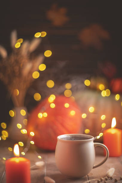 istock Autumn cozy composition. Tea in a mug, pumpkins and candles 1761319549