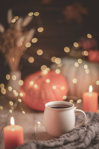 istock Autumn cozy composition. Tea in a mug, pumpkins and candles 1761321294
