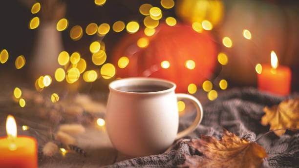 istock Autumn cozy composition. Tea in a mug, pumpkins and candles 1761322445